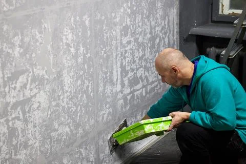 Craftsman applying decorative plaster. Applying decorative plaster with trowe Stock Photos