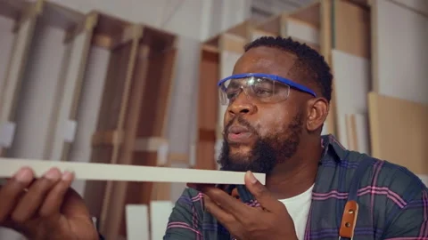 Craftsman blowing dust from the wood. Stock Footage 229466341