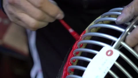 Craftsman brushes bright red lacquer onto the front rim of a kendo mask grille Vídeo Stock 346737945