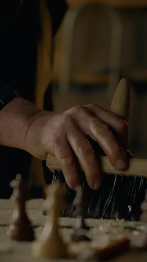 Craftsman carefully clears sawdust while shaping furniture with precision to Stock Footage 331540690