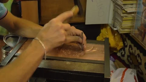 A craftsman creates a work of art by punching copper, in Mostar, Bosnia Stock Footage 241641785