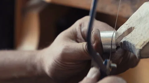 Craftsman cuts silver. handmade silver jewelery gems. cuts the silver bar Stock Footage 136245345
