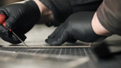 Craftsman cutting leather pattern with awl tool Stock Footage 318847973
