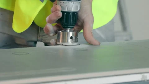 A craftsman drills a round hole in a ceramic tile with a diamond bit, close-up. Stock Footage 211874595