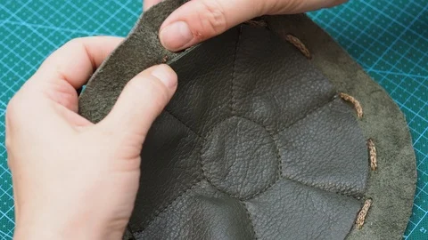 Craftsman inserts a cord in the sewn pouch Stock Footage 97415735