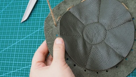 Craftsman inserts a string in the sewn pouch Stock Footage 97415615
