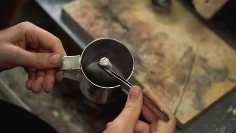 Craftsman made immersion the silver ring in the special ammonia solution for Stock Footage 73462903