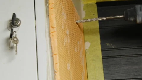 Craftsman makes hole in surface with applied installation board Stock Footage 304412235