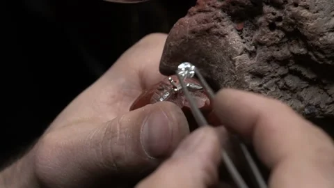 Craftsman making diamond ring. Put diamond gem ring. diamond ring production Stock Footage 139730953