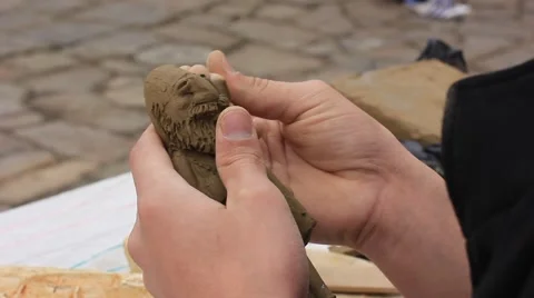 Craftsman making a doll from clay Stock Footage 56399304