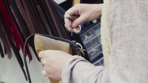 Craftsman making leather belt Stock Footage