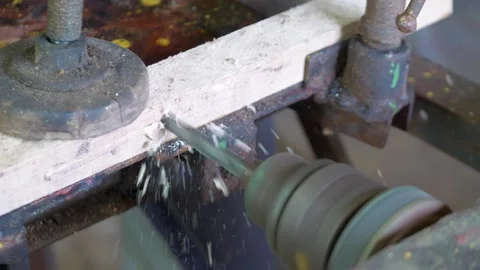 A craftsman manually drilling a hole in a metal piece using a vintage hand .. Stock Footage 282979518