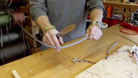 Craftsman measuring silver color string to make new bracelet, workshop 動画素材 160311081