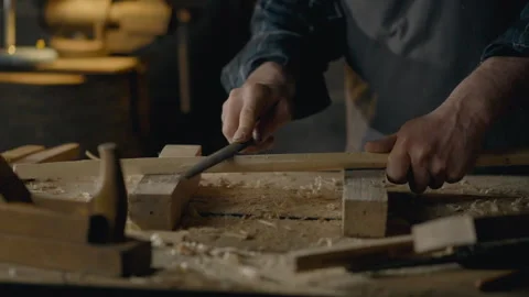 Craftsman, Middle-aged man Concentrated Uses hand tool rasp In a carpentry w Video stock 242993146