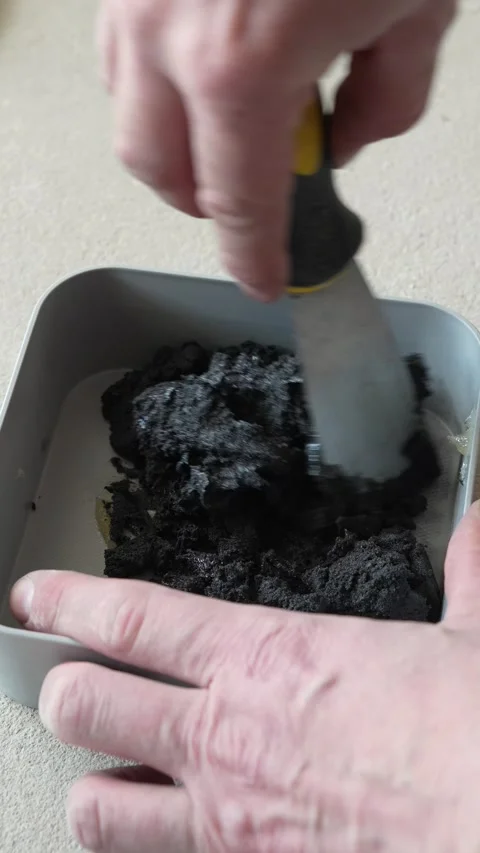 The craftsman is mixing epoxy grout in a container Stock Footage 317902483