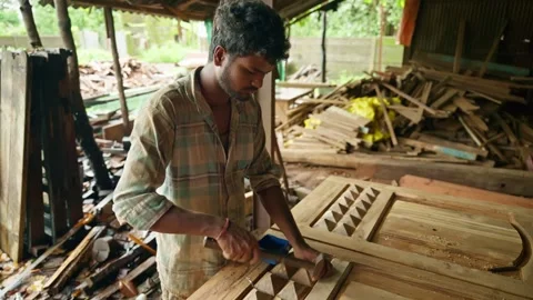 Craftsman mount decor piece onto oak frame in shop Stock Footage 310718397