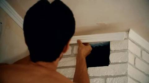 Craftsman mounting a polyurethane ceiling molding Stock Footage 71312775