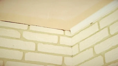 Craftsman mounting a white ceiling molding Stock Footage 71313109