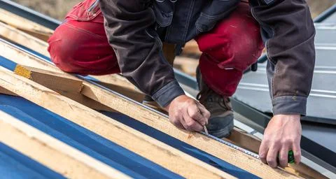 Craftsman or construction worker install a new roof, roofing tools, new metallic Фото
