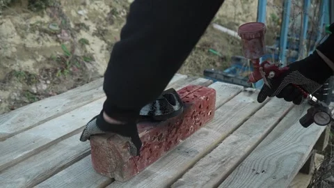 Craftsman paints a metal structure using a spray gun Stock Footage 261282237