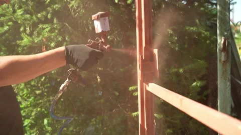 Craftsman paints a metal structure using a spray gun Video stock 261282292