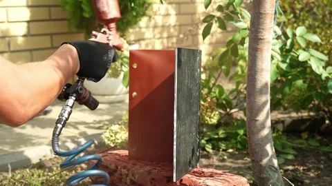 Craftsman paints a metal structure using a spray gun Video stock 261282299