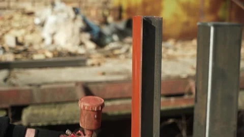 Craftsman paints a metal structure using a spray gun Stock Footage 266806150