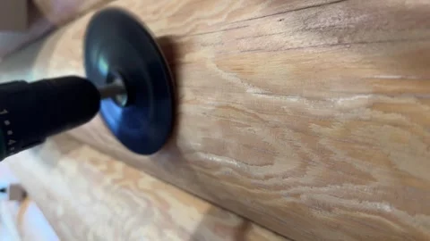 Craftsman polishes a solid wood board with a sander, furniture restoration. Stock Footage 302963574