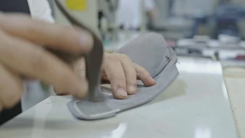 Craftsman preparing details of a future shoe, glues reinforcing materials Stock Footage 123414146