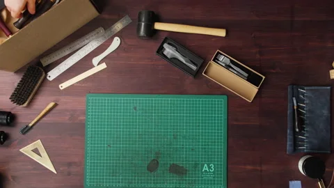 Craftsman preparing instruments at his workplace before repairing leather things Stock Footage 157451008