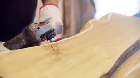 Craftsman in protective gloves using electric grinding machine for sharpening Stock-Footage 263054277