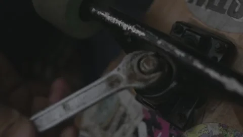 Craftsman repairs the longboard with a wrench to replace kingpin and bushing Stock Footage 162726207