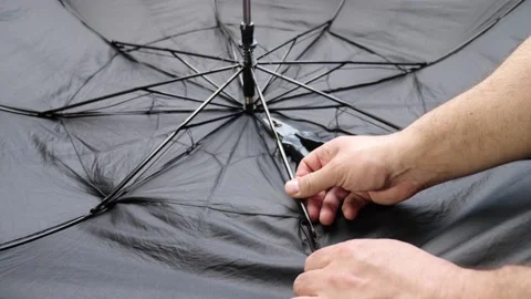 A craftsman repairs an umbrella by changing the needle with a hand tool. Small r Stock Footage 237153111