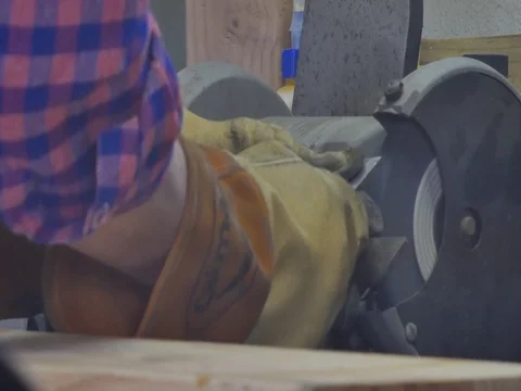 Craftsman sharpening his tool at workbench Video stock 76991827