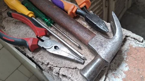 Craftsman sharpening scissors with a whetstone. Professional barber tools Stock Photos