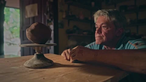 Craftsman spins artwork ceramic pot. Potter works on handmade clay flowerpot Stock Footage 264099573