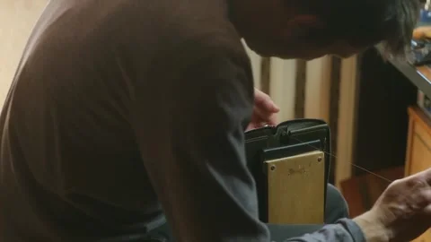 Craftsman stitches leather wallet using durable threads Stock-Footage 296748161