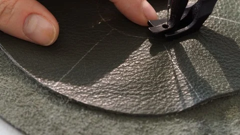 Craftsman stitches the pouch on sewing machine close up Stock Footage 97415284