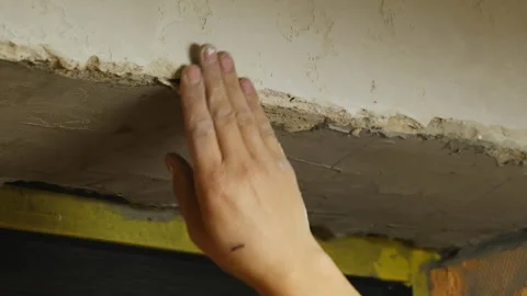 Craftsman strikes concrete surface with hammer during demolition Stock Footage 304412853