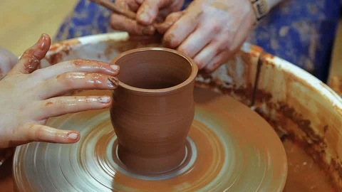The craftsman teaches the child to make a ceramic Cup Stock Footage 97873654