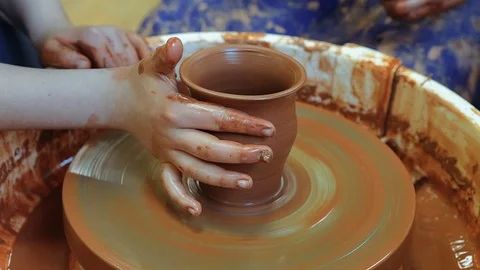 The craftsman teaches the child to make a ceramic Cup Stock Footage 97873756