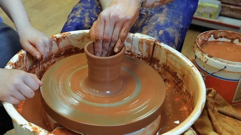 The craftsman teaches the child to make a ceramic Cup Stock Footage 97873897
