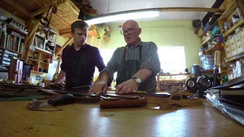 Craftsman teaching apprentice in workshop Video stock 72966441