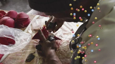 Craftsman threading awl and assembling red cones with gold trim and floating Stock Footage 313678120