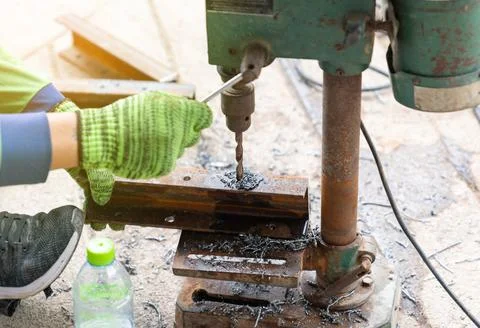 Craftsman use old drill in construction site. Stock Photos
