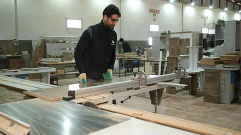 Craftsman using electric saw on workbench in woodworking shop Video stock 327592688