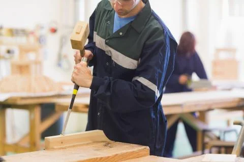 Craftsman using mallet and chisel Stock Photos