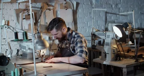 Craftsman using sewing machine in workshop Stock Footage 172488730