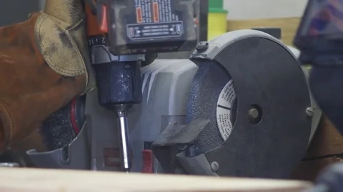 Craftsman welder uses a drill to make handmade furniture at his workbench Video stock 76991809