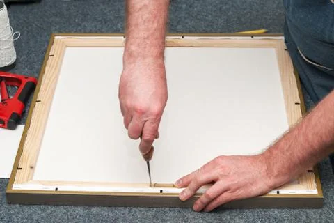 Craftsman working on frame in frameshop. Copy space. Top view Stock Photos